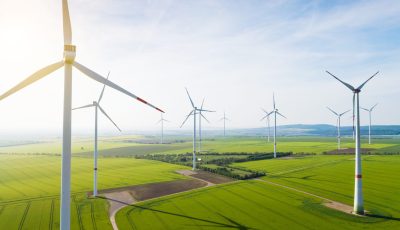 Aerial view of wind turbines and agriculture field